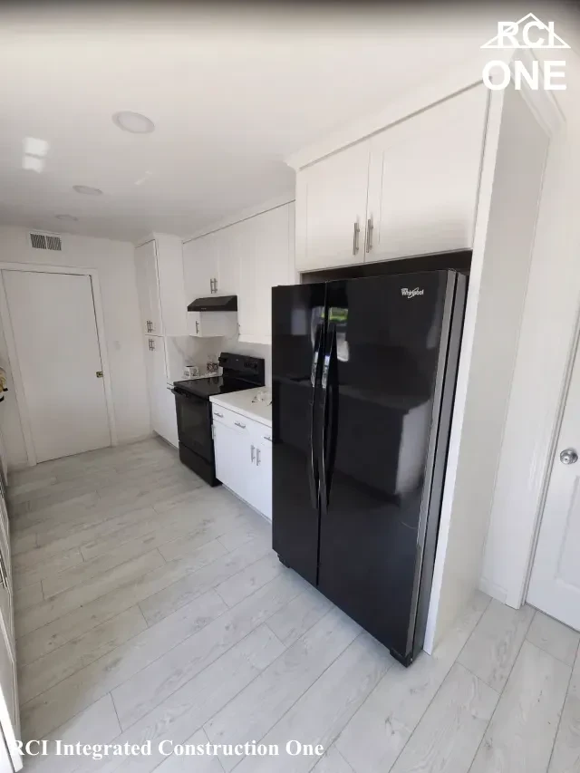 Modern White Kitchen with Black Appliances